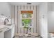 Well-lit mud room with checkered floors, white cabinets, and a window at 5217 Addison Ave, Charlotte, NC 28211