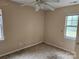 A vacant bedroom awaiting personal touches and updates, bathed in natural light from its windows at 5315 Airport Dr, Charlotte, NC 28208