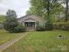 Charming single-story home with a well-maintained front yard and inviting walkway leading to the entrance at 5315 Airport Dr, Charlotte, NC 28208