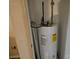 Close-up of a hot water heater in a small closet with some other items for storage at 5315 Airport Dr, Charlotte, NC 28208