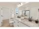 Bathroom featuring double sinks, granite countertop, white cabinets, and a walk-in shower at 6117 Grove Park Blvd, Charlotte, NC 28215