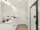 Bright bathroom with double sinks, granite countertop, and a walk-in shower with black trim at 6117 Grove Park Blvd, Charlotte, NC 28215