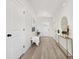 Bright hallway with a bench and decorative table with a view to the front door at 6117 Grove Park Blvd, Charlotte, NC 28215