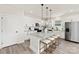 Stylish kitchen with white cabinets, granite counters, stainless appliances, an island, and bar stool seating at 6117 Grove Park Blvd, Charlotte, NC 28215