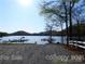 Scenic view of a boat ramp leading to a serene lake with docks and boats at 630 Pinelake Dr, Troy, NC 27371