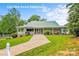 Picturesque clubhouse with a covered porch, lush landscaping, and well-maintained lawn at 630 Pinelake Dr, Troy, NC 27371