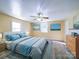 This bedroom has a neutral color scheme, plank flooring, and multiple windows at 704 Mill St, Albemarle, NC 28001