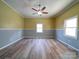 A bright bedroom with neutral walls, new floors, and natural light from multiple windows at 704 Mill St, Albemarle, NC 28001