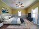 Bright bedroom features a ceiling fan, area rug, and neutral color scheme at 704 Mill St, Albemarle, NC 28001