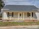 Traditional home with a covered front porch supported by classic columns, windows with black shutters at 704 Mill St, Albemarle, NC 28001