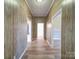Hallway with a wood accent wall and floors that leads to the living spaces and bedrooms at 704 Mill St, Albemarle, NC 28001