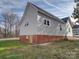 This home features light-colored siding and classic brick, with a well-maintained lawn at 704 Mill St, Albemarle, NC 28001