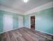 This open room has fresh paint, new flooring, and multiple doorways at 704 Mill St, Albemarle, NC 28001