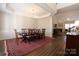 Elegant dining room with a large table, hardwood floors, and a decorative ceiling at 815 Treverton Dr, Matthews, NC 28105