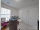 Bright bedroom with white walls, double closet, carpeted floor, and natural light coming through the window at 8353 Emily Dr, Harrisburg, NC 28075