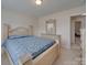 Comfortable bedroom featuring light-colored wood trim, a large bed, and a sunny window creating a relaxing ambiance at 8353 Emily Dr, Harrisburg, NC 28075