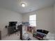 Bedroom featuring a ceiling light and window with blinds, and a desk area at 8353 Emily Dr, Harrisburg, NC 28075