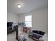 Bedroom featuring a ceiling light and window with blinds, and a desk area at 8353 Emily Dr, Harrisburg, NC 28075