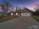 Charming brick home with a two-car garage and a well-manicured lawn, offering curb appeal and convenience at 8353 Emily Dr, Harrisburg, NC 28075