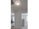 Bright hallway shows open doorway to a room with a sofa and second doorway to bedroom at 8353 Emily Dr, Harrisburg, NC 28075
