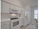 Well-lit kitchen with white cabinetry, modern appliances, and plenty of counter space at 8353 Emily Dr, Harrisburg, NC 28075