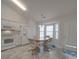 Bright eat-in kitchen features white appliances, cabinetry, and a sunny bay window for a cheerful dining space at 8353 Emily Dr, Harrisburg, NC 28075