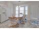 Bright eat-in kitchen features white appliances, cabinetry, and a sunny bay window for a cheerful dining space at 8353 Emily Dr, Harrisburg, NC 28075
