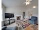 Cozy living room with a brick fireplace, modern TV, and comfortable seating for relaxation at 8353 Emily Dr, Harrisburg, NC 28075