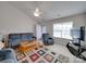 Bright living room with ample seating, a ceiling fan, and a large window for natural light at 8353 Emily Dr, Harrisburg, NC 28075