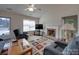 Inviting living room featuring a cozy fireplace, large window, and comfortable seating arrangement at 8353 Emily Dr, Harrisburg, NC 28075