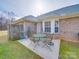 A backyard patio with brick accents, a round table, and seating, creating an inviting outdoor space at 8353 Emily Dr, Harrisburg, NC 28075