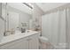 Clean bathroom with a white vanity and shower, providing a functional and updated space at 8701 Gainsford Ct, Charlotte, NC 28210