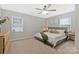 Comfortable bedroom with neutral tones, ceiling fan, and bright windows offers a peaceful retreat at 8701 Gainsford Ct, Charlotte, NC 28210