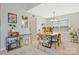 Bright dining room with a modern chandelier, and backyard view at 8701 Gainsford Ct, Charlotte, NC 28210