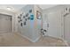 Neutral entryway with carpet flooring, decorative wall art, and direct access to the front door at 8701 Gainsford Ct, Charlotte, NC 28210