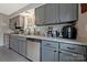 Kitchen with granite countertops, gray cabinetry, stainless steel appliances, and ample storage at 8701 Gainsford Ct, Charlotte, NC 28210