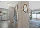 Kitchen with stainless steel refrigerator, adjacent to a casual living area with access to the backyard at 8701 Gainsford Ct, Charlotte, NC 28210