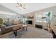 Comfortable living room with a brick fireplace and sliding door access to backyard at 8701 Gainsford Ct, Charlotte, NC 28210
