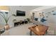 Open living room features a large TV, modern decor, and a comfortable sofa at 8701 Gainsford Ct, Charlotte, NC 28210