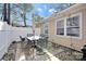 Outdoor patio with a dining table and string lights creates a cozy and inviting space at 8701 Gainsford Ct, Charlotte, NC 28210