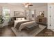 Bright bedroom featuring a ceiling fan, area rug, bench, and multiple windows at 8723 Totteridge Dr, Charlotte, NC 28277