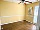Bedroom featuring a ceiling fan, chair railing, and wood-look flooring at 8723 Totteridge Dr, Charlotte, NC 28277