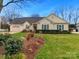 Charming single-story home with a well-manicured lawn and attached garage at 8723 Totteridge Dr, Charlotte, NC 28277