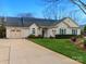 View of a single Gathering home showing the driveway, and well-maintained landscaping at 8723 Totteridge Dr, Charlotte, NC 28277