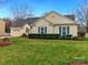 Well-kept single-story home with green shutters and a tidy front lawn at 8723 Totteridge Dr, Charlotte, NC 28277