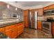 Spacious kitchen with stainless steel appliances, custom cabinetry, and wood flooring at 8723 Totteridge Dr, Charlotte, NC 28277