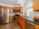 Kitchen features stainless steel appliances, granite countertops, and modern lighting at 8723 Totteridge Dr, Charlotte, NC 28277