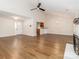 Open-concept living room featuring wood-look flooring, a fireplace, and an eat-in kitchen at 8723 Totteridge Dr, Charlotte, NC 28277