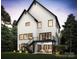 Spacious backyard features a modern white home with black trim, a balcony, and a staircase at 910 Laurel Creek Ln, Charlotte, NC 28211