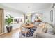 Bright dining area features a round wooden table, stylish seating, and a large window overlooking the front lawn at 9417 Valley Rd, Charlotte, NC 28270